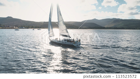 Closeup of yacht sail at ocean sun reflection aerial. Close up sailboat at ocean. Scotland seascape 113523572