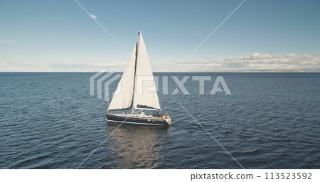 Slow motion sun reflection at yacht on ocean bay aerial. Sailing regatta race on boat at sunshine 113523592