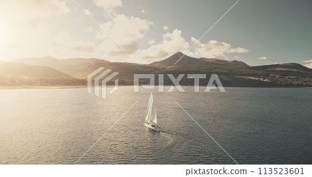 Sun reflection at ocean bay with sailboat. Aerial yacht cruise at sunlight. Summer luxury travel Sun reflection at ocean bay with sailboat. Aerial yacht cruise at sunlight. Summer luxury travel 113523601