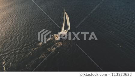 Yacht sailing on open sea at sun shine aerial. Serene seascape and water transportation, sail boat 113523623
