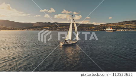 Sailboats at ocean coast aerial. Summer cruise on luxury passenger yacht. Scotland sea shore Sailboats at ocean coast aerial. Summer cruise on luxury passenger yacht. Scotland sea shore 113523635