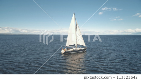 Slow motion of yacht reflection at sea gulf aerial. Sail boat reflect at ocean bay. Racing sailboat Slow motion of yacht reflection at sea gulf aerial. Sail boat reflect at ocean bay. Racing sailboat 113523642