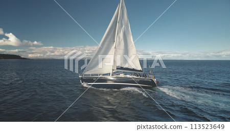 Slow motion closeup of sail luxury yacht at ocean bay aerial. Sailboat regatta race at open sea 113523649