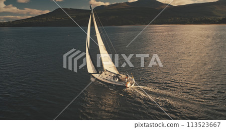 Sailboat at mountain island aerial. Nobody nature seascape. Luxury yacht sailing at open sea Sailboat at mountain island aerial. Nobody nature seascape. Luxury yacht sailing at open sea 113523667