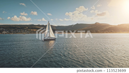 Sailing at racing yacht in open sea, sun shine aerial view. Majestic seascape at Arran Island coast Sailing at racing yacht in open sea, sun shine aerial view. Majestic seascape at Arran Island coast 113523699