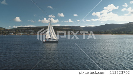 Closeup yacht racing at port town on ocean coast aerial. Sailboat regatta under sails at open sea 113523702