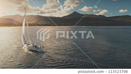 Sailing yacht in wind waves at Arran Island sea bay, Scotland. Amazing seascape at Brodick port city Sailing yacht in wind waves at Arran Island sea bay, Scotland. Amazing seascape at Brodick port city 113523706