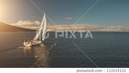 Sun over sailing regatta on luxury yachts aerial. Majestic sail boats race at ocean Brodick harbour 113524132