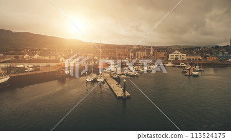 Sun over ships, yachts at sea bay aerial. Port cityscape with ancient architecture at ocean coast 113524175