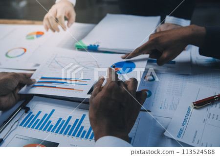 Business idea. Business people talking And calculations about charts and graphs showing the growth of investment results Of successful teamwork Business idea. Business people talking And calculations about charts and graphs showing the growth of investment results Of successful teamwork 113524588