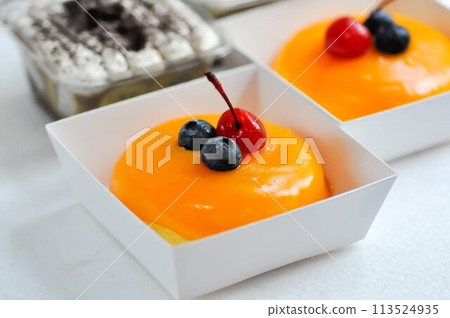 orange cake with cherry and blueberry topping or fruit cake or glaze cake 113524935