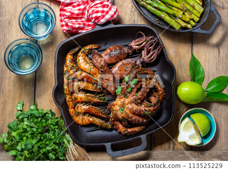 Grilled spimps, squids and octopus in cast iron grill pan Grilled spimps, squids and octopus in cast iron grill pan 113525229