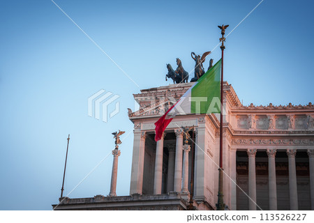 Neoclassical building in Italy showcasing Italian flag, statues, intricate details, clear sky. Grand architectural design with historical significance. Neoclassical building in Italy showcasing Italian flag, statues, intricate details, clear sky. Grand architectural design with historical significance. 113526227