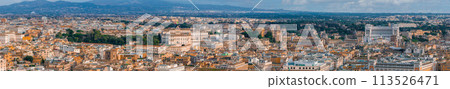An aerial panorama of Rome shows terracotta rooftops and green canopies, blending ancient and modern architecture. An aerial panorama of Rome shows terracotta rooftops and green canopies, blending ancient and modern architecture. 113526471