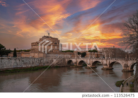 A scenic view of Castel Sant'Angelo and Ponte Sant'Angelo bridge over Tiber River in Rome, Italy. Historical landmarks, river, and cloudy sky with hints of blue. A scenic view of Castel Sant'Angelo and Ponte Sant'Angelo bridge over Tiber River in Rome, Italy. Historical landmarks, river, and cloudy sky with hints of blue. 113526475