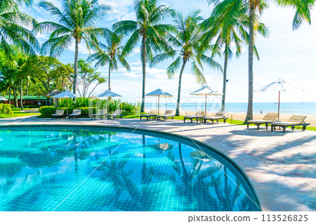 Beautiful umbrella and chair around swimming pool in hotel and resort 113526825