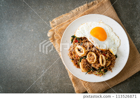 fried rice with squid and basil topped fried egg in Thai style 113526871