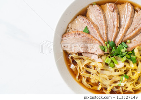 egg noodles with stewed duck in brown soup 113527149