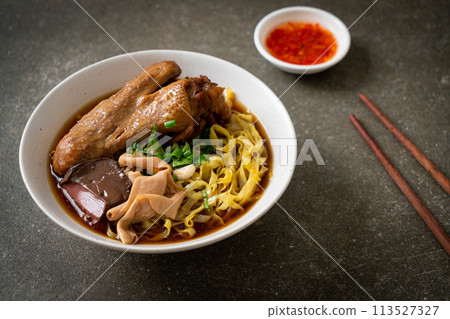 egg noodles with stewed and braised duck in brown soup 113527327