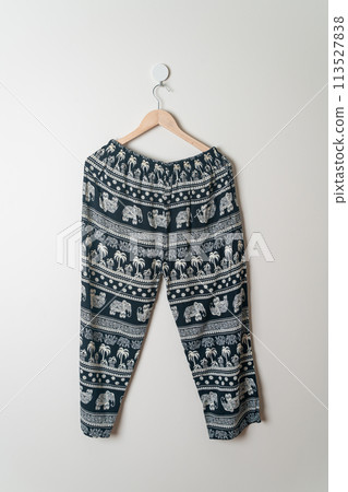 trousers or long pants hanging on wall 113527838