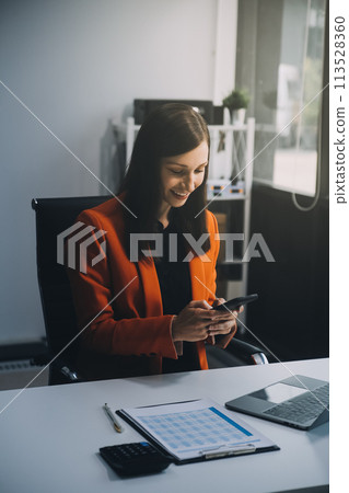 Businessman working at office with calculator documents phone laptop on desk, Asian woman doing planning analyzing the financial report, business plan investment, finance analysis concept 113528360