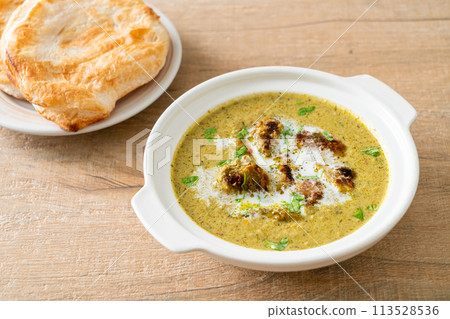 Afghani chicken in green masala curry or Hariyali tikka chicken hara masala with roti or naan bread Afghani chicken in green masala curry or Hariyali tikka chicken hara masala with roti or naan bread 113528536
