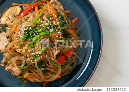 japchae or stir-fried Korean vermicelli noodles with vegetables and pork topped with white sesame japchae or stir-fried Korean vermicelli noodles with vegetables and pork topped with white sesame 113528612