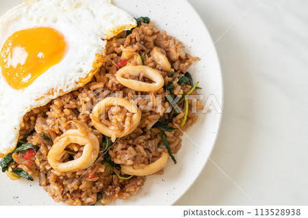 fried rice with squid and basil topped fried egg in Thai style fried rice with squid and basil topped fried egg in Thai style 113528938