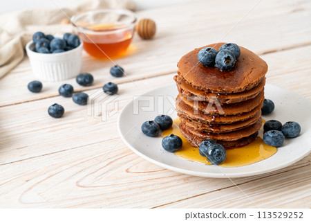 chocolate pancake stack with blueberry and honey chocolate pancake stack with blueberry and honey 113529252