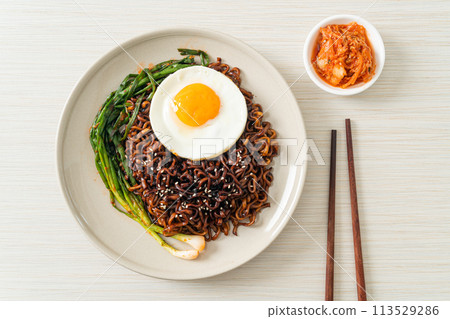 dried Korean spicy black sauce instant noodles with fried egg and kimchi dried Korean spicy black sauce instant noodles with fried egg and kimchi 113529286