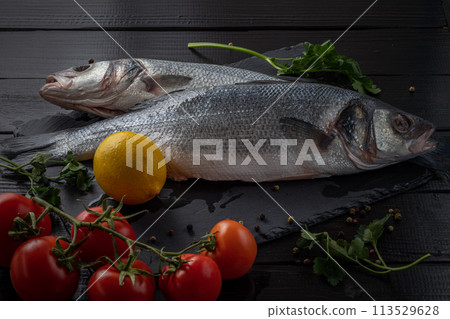 Sea bream or dorado sea fish herbs on dark slate background Top view  113529628