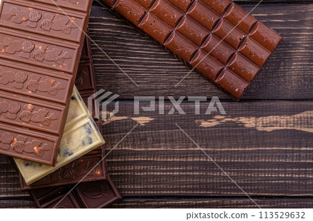 Chocolate bar pieces. Background with chocolate. Sweet food photo concept. Chocolate bar pieces. Background with chocolate. Sweet food photo concept. 113529632