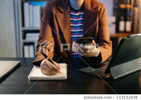 business hands working with digital tablet computer and smart phone with financial business strategy layer effect on desk . 113532036