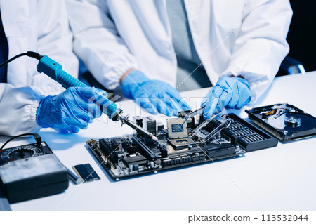 The technician is putting the CPU on the socket of the computer motherboard. electronic engineering electronic repair, electronics measuring. 113532044