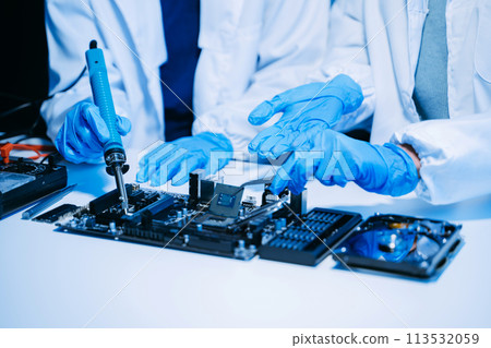 The technician is putting the CPU on the socket of the computer motherboard. electronic engineering electronic repair, electronics measuring. The technician is putting the CPU on the socket of the computer motherboard. electronic engineering electronic repair, electronics measuring. 113532059