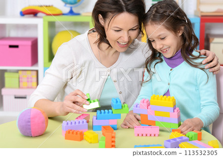 Portrait of cute little girl playing with colorful clay blocks  113532305