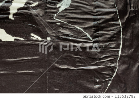 Old grunge ripped torn black paper poster surface texture background 113532792