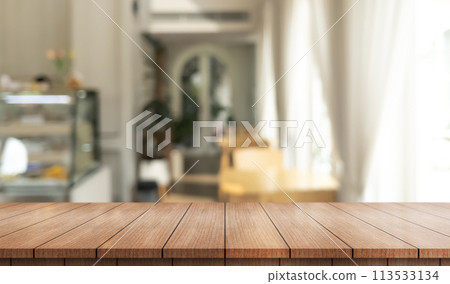 Empty wooden table top with lights bokeh on blur restaurant background 113533134
