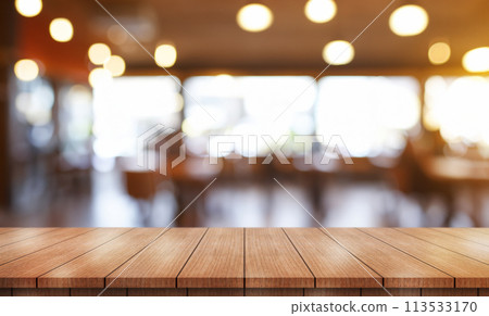 Empty wooden table top with lights bokeh on blur restaurant background 113533170
