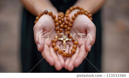 Soulful prayer: a man in quiet devotion, hands clasped around a rosary cross, seeking solace and spiritual connection, capturing the essence of serene contemplation, faith, and religious devotion. 113533360
