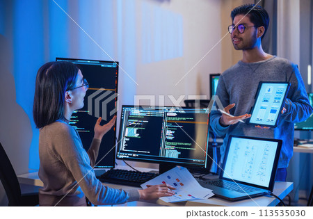 asian and Indian Developer  devops team discussion  about coding promgram with software computer at night in office 113535030