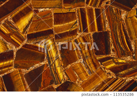 Tigers Eye Golden natural semi precious brown stone texture for unique design interior. Tigers Eye Golden natural semi precious brown stone texture for unique design interior. 113535286