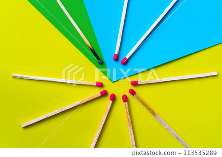 Success, defeat, achievement. The concept of happiness. Matches on a yellow background. Burnt dark match among normal matches. Burning match fire to its neighbors, a metaphor for ideas and inspiration Success, defeat, achievement. The concept of happiness. Matches on a yellow background. Burnt dark match among normal matches. Burning match fire to its neighbors, a metaphor for ideas and inspiration 113535289