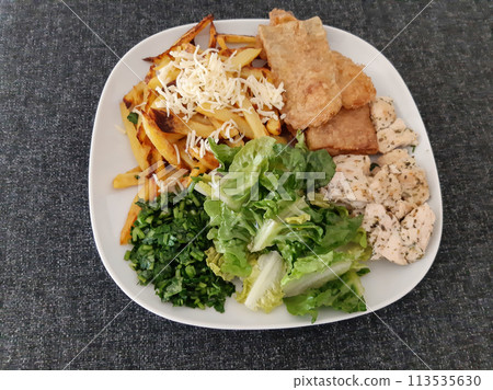 Homemade grilled chicken with grilled zucchini, green salad, french fries, cheese and parsley Homemade grilled chicken with grilled zucchini, green salad, french fries, cheese and parsley 113535630