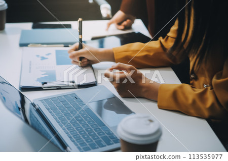 Financial Business team present. Business man hands hold documents with financial statistic stock photo, discussion, and analysis report data the charts and graphs. Finance Financial concept 113535977