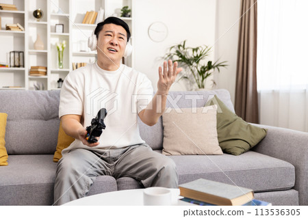 Frustrated Gamer Losing Video Game on Couch at Home 113536305