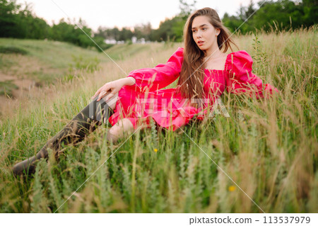 Happy woman in the blooming field. Nature, vacation, relax and lifestyle. Summer landscape. 113537979