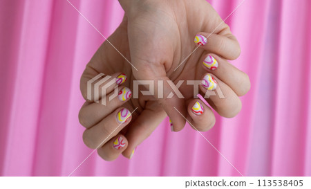 Woman manicured hands, stylish summer colorful nails on pink background. Closeup of manicured nails of female hand. Summer style of nail design concept. Beauty 113538405