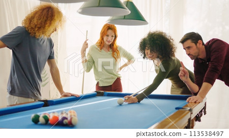 Beginner player hitting a billiard ball and laughing happy 113538497