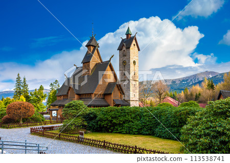 Medieval Norwegian wooden church Vang or Wang and Snezka mountain in the background. Karpacz, Poland 113538741